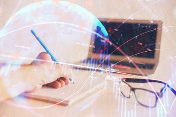 Multi exposure of man hands with stock market forex graph.