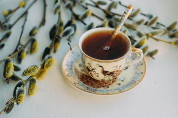 a Cup of tea and willow twigs on the windowsill