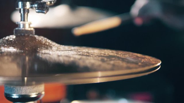 Wet cymbals on drumkit. Drummer, drumset, drums in slow motion