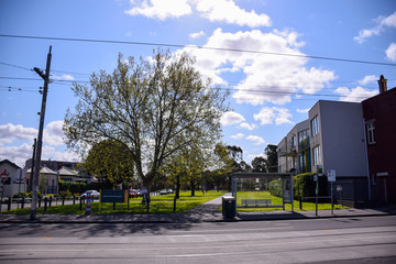 The houses with green grass field and cloudy blue sky background on sunny day in Melbourne, Australia