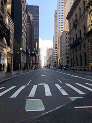 Manhattan, New York, USA. 2020. Looking south on 5th Avenue at 55th Street - Usually very busy shopping area in Midtown.  Seen during the Coronavirus lockdown period.
