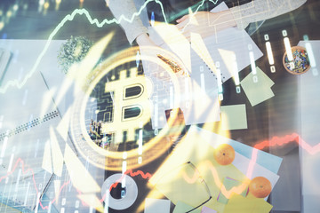 Cryptocurrency hologram over woman's hands writing background. Concept of blockchain. Multi exposure