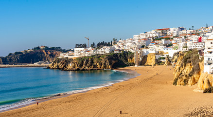 Fototapeta premium Wide sandy beach in white city of Albufeira, Algarve, Portugal