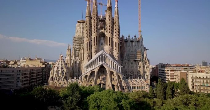 La Sagrada familia cathedral, Aerial drone shot, vertical panning the La Sagrada familia cathedral, over the city of Barcelona, at sunset.