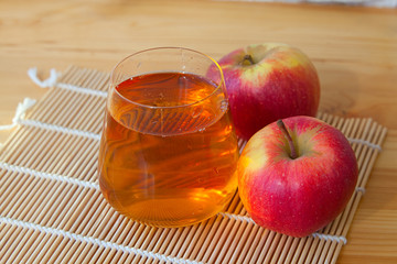 Delicious fresh squeezed apple juice in  transparent glass