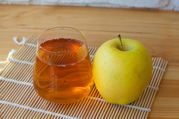 Delicious fresh squeezed apple juice in  transparent glass