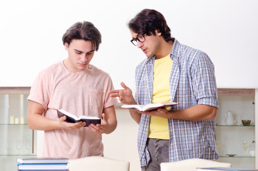 Two male students preparing for exams at home