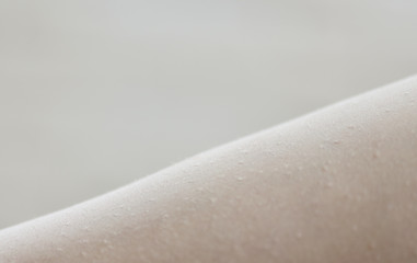 Female legs with talcum powder during hair depilation. Close-up