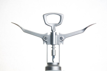 Metallic corkscrew with two levers like humanoid robot spreads it's arms wide on a white background.