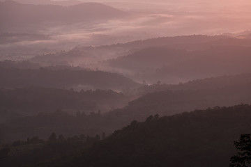 Twilight, sunrise and sea of fog in the morning on the mountains of northern Thailand, during the rainy season.