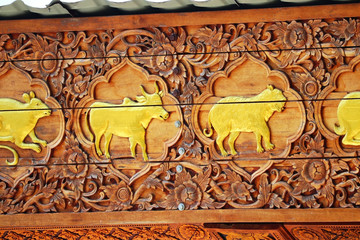 Very colourful ancient asian bas-relief with golden animal elements in Wat Phrathat Doi Suthep