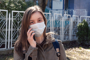 Woman in mask on street because of air pollution and epidemic in city