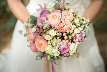Bridal bouquet of roses, eustoma and ornamental plants
