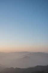 Twilight, sunrise and sea of fog in the morning on the mountains of northern Thailand, during the rainy season.