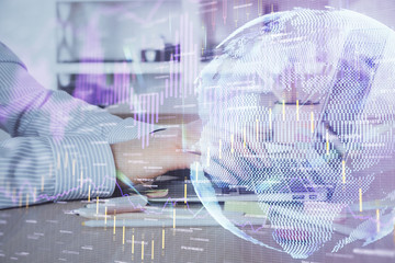 Double exposure of stock market graph with man working on laptop on background. Concept of financial analysis.