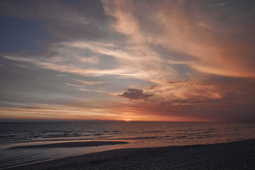 Fototapeta na wymiar Stunning colorful sunset on a sandy beach.