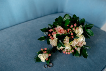 Fototapeta na wymiar Bridal bouquet of roses, eustoma and ornamental plants on a textile background 
