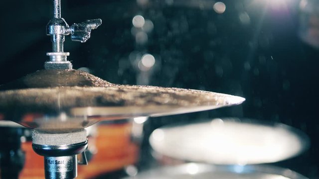 Man plays drums in a studio, hitting cymbals. Drummer, drumset, drums in slow motion