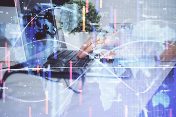 Double exposure of businessman working on laptop on background. International business hologram in front. Concept of success.