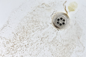 Sand and dirt in the bathroom. The concepts of cleanliness and hygiene. Close-up