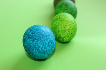 Lots of colored eggs on a green background.