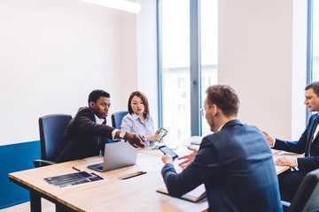 Multiethnic group of people at office using devices