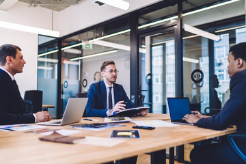 Group of young people talking in office