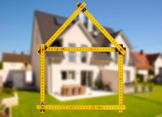 newly built house with a yardstick