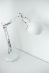 White desk lamp on white table