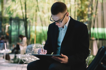 Male artist with tablet working outside
