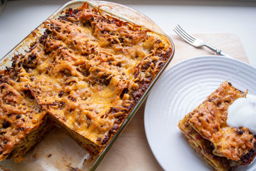 Juicy meat lasagna, cassic dish of Italian cuisine with dough, meat and sauce with creamy soft mozzarella cheese.