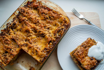 Juicy meat lasagna, cassic dish of Italian cuisine with dough, meat and sauce with creamy soft mozzarella cheese.