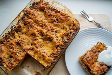 Juicy meat lasagna, cassic dish of Italian cuisine with dough, meat and sauce with creamy soft mozzarella cheese.