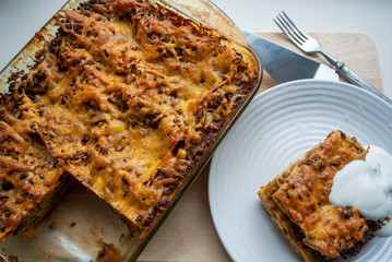 Juicy meat lasagna, cassic dish of Italian cuisine with dough, meat and sauce with creamy soft mozzarella cheese.