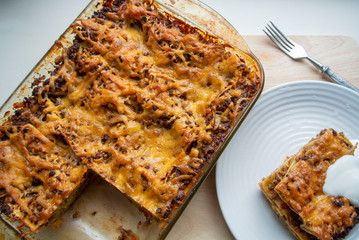 Juicy meat lasagna, cassic dish of Italian cuisine with dough, meat and sauce with creamy soft mozzarella cheese.