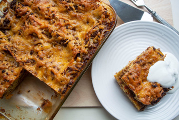 Juicy meat lasagna, cassic dish of Italian cuisine with dough, meat and sauce with creamy soft mozzarella cheese.