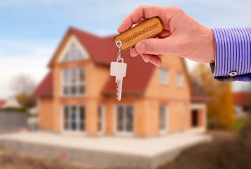 newly built home with a yardstick house key