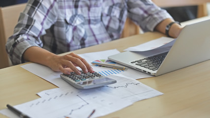 close up of a male hands typing on calculator