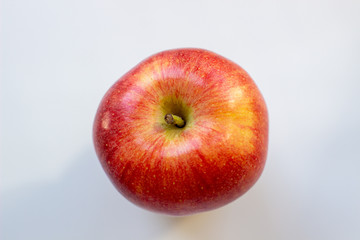 Three apples, one green and two red-yellow on a light background.