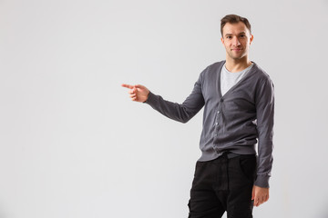 Young man presenting your product, isolated over a white background