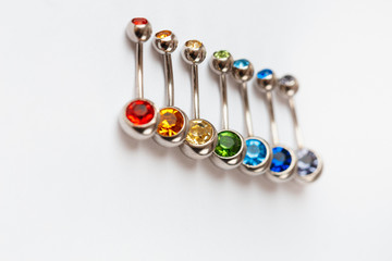 7 multicolored navel piercing earrings - red, orange, yellow, green, blue, indigo blue and purple....
