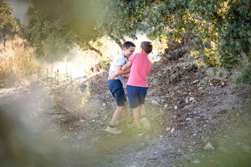 Two boys playing in nature. Siblings love.