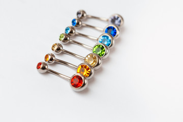 7 multicolored navel piercing earrings - red, orange, yellow, green, blue, indigo blue and purple....