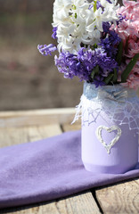 beautiful purple hyacinths in a vase, photographed in nature on a sunny day