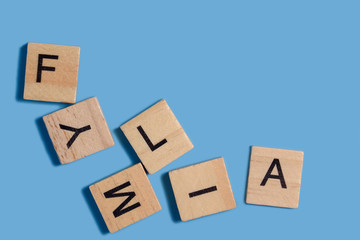 letters FAMILY. Wood alphabet or letters boxes state word. Family conflict and difficulties.