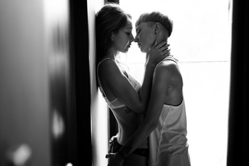 Beautiful young sexy lesbian couple tenderly hugs and kisses, love happiness tolerance LGBT concept