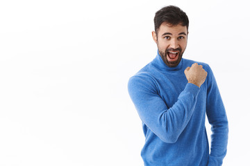 Enthusiastic and optimistic, confident happy caucasian guy encouraging keep going, fist pump and smiling, feel upbeat ready to go towards dream, dressed for success, standing white background