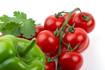 Green pepper and red tomatoes on a white background