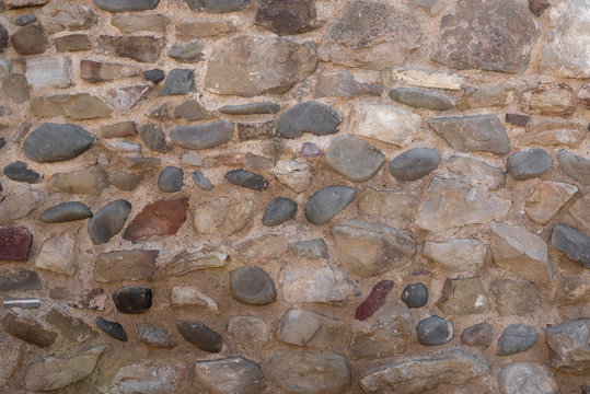 Textured stones stacked on top of each other, abstract ones cement between them