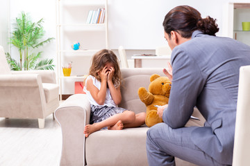 Child psychologist attending small girl